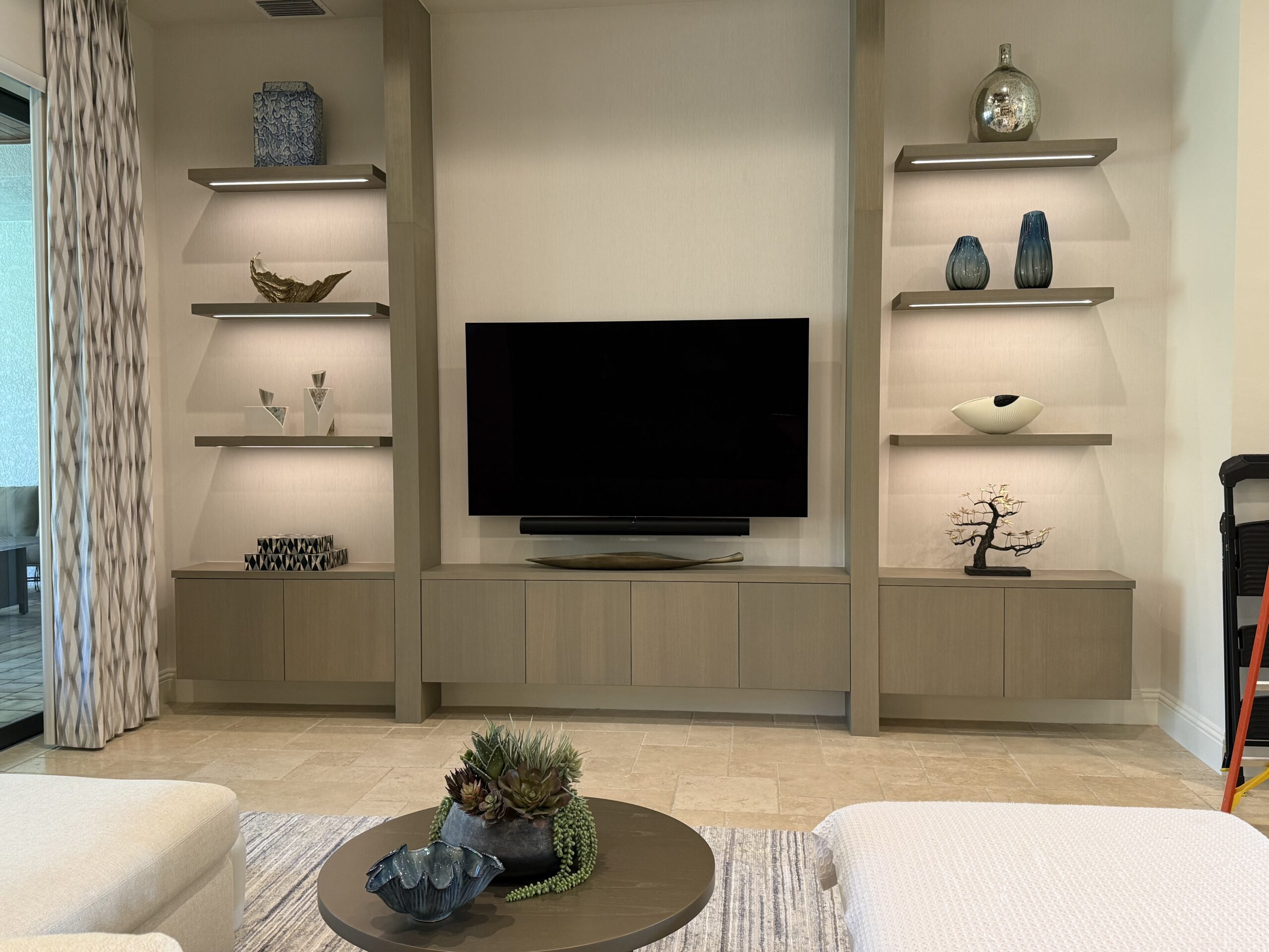 Accessory installation in shelving TV area.